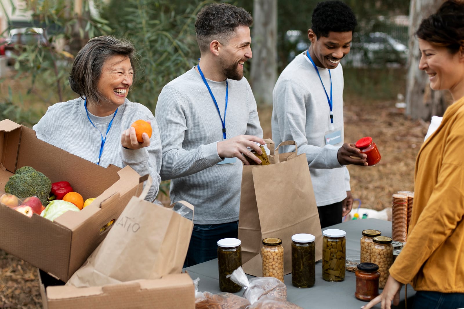 People packing fresh produce and pantry food at a community distribution