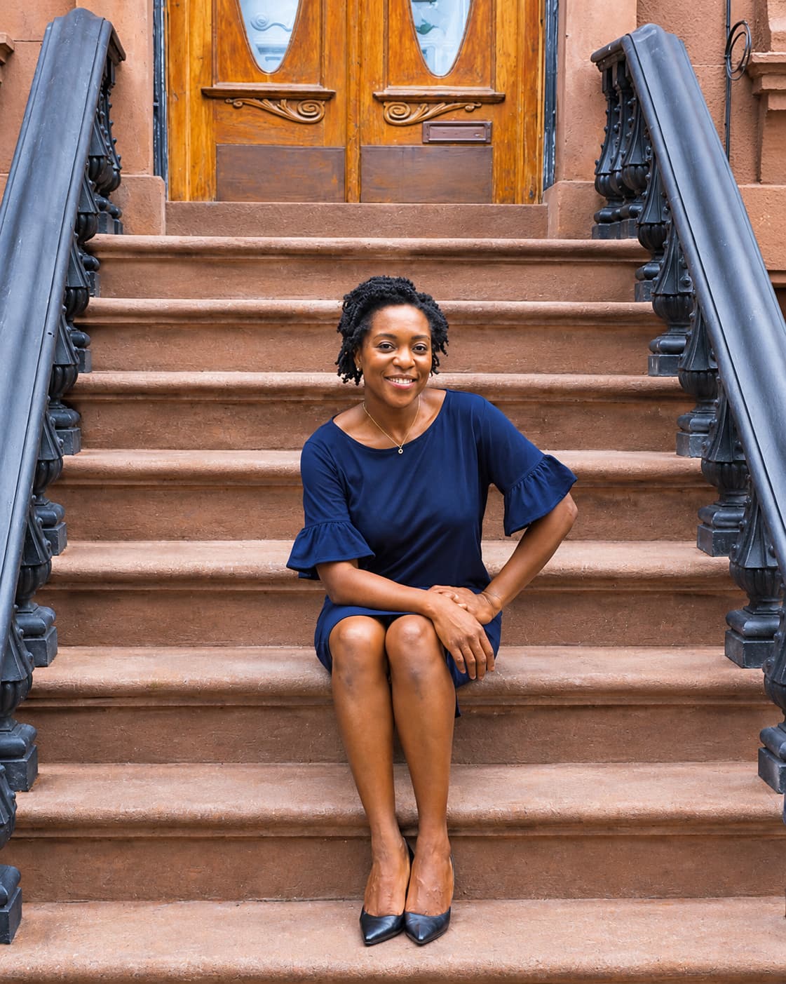 Maya Feller seated on brownstone steps